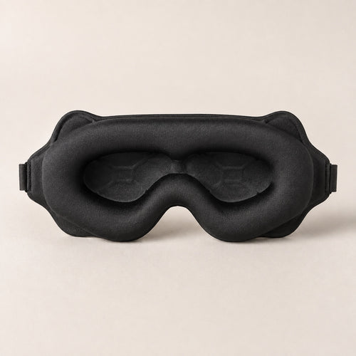 Inner face of the sleep mask showing the padded perimeter, recessed eye cups and shaped nose opening.