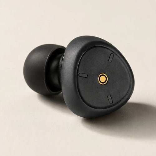 Close-up of the shallow black earplug cap, gold centre detail and silicone tip.