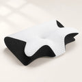 Contoured pillow with white quilted top and black mesh sides on an ivory studio background.